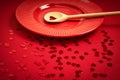 Valentines Day background with red ribbed paper with red plate and wooden spoon for lovers Royalty Free Stock Photo