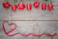 Valentines day background with red rose and ribbon on wooden. Royalty Free Stock Photo