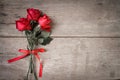 Valentines day background with red rose and ribbon on wooden. Dual tone. Royalty Free Stock Photo