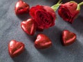 Valentines day background. Red roses and chocolate hearts on grey Royalty Free Stock Photo