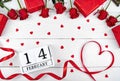 Valentines Day background with red roses, gift boxes, ribbon shaped as heart and wooden block calendar february 14 , copy space. Royalty Free Stock Photo