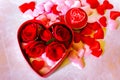 Valentines Day background. Red Roses with hearts and candle on pink background Royalty Free Stock Photo