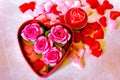 Valentines Day background. Red Roses with hearts and candle on pink background Royalty Free Stock Photo