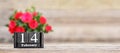 Valentines Day background with red roses and wooden retro calendar