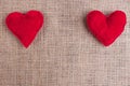 Valentines Day background with two red fabric hearts on sackclot Royalty Free Stock Photo