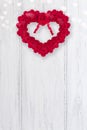 Valentines Day background, white wooden door with red heart shaped rose wreath and bokeh, vertical format, copy space Royalty Free Stock Photo