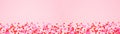 Valentines Day banner with border of candy heart sprinkles over a pink background with copy space Royalty Free Stock Photo