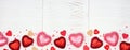 Valentines Day banner with heart decor border against a white wood background with copy space Royalty Free Stock Photo