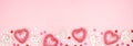 Valentines Day banner with long border of pink and white heart decorations against a pink background with copy space Royalty Free Stock Photo