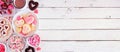 Valentines Day banner with side border of assorted sweets and cookies, above view over a white wood background with copy space Royalty Free Stock Photo