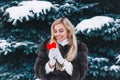 Valentines day. Beautifull smiling woman holding red heart in the hands in the forest Royalty Free Stock Photo