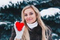 Valentines day. Beautifull smiling woman holding red heart in the hands in the forest . Royalty Free Stock Photo