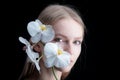 Valentines Day. Beauty girl with tulip in orchid. Beautiful sensual woman with orchid flower, studio portrait on black Royalty Free Stock Photo