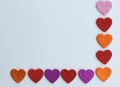 Valentines Day border of colorful paper hearts over a white background Royalty Free Stock Photo