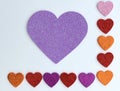 Valentines Day border of colorful paper hearts over a white background Royalty Free Stock Photo