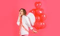Valentines day celebration. Angel girl in angelic wings with red heart balloons. Cute female cupid. Royalty Free Stock Photo