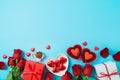 Valentines day celebration concept with heart shape chocolate, gift box and  rose flowers on blue background. Top view. Flat lay Royalty Free Stock Photo