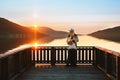 Valentines Day celebration: Romantic couple in love man and woman hugging on pier enjoying sunset view Royalty Free Stock Photo