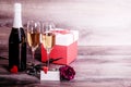 Champagne, rose, a gift and a lovely message on the table Royalty Free Stock Photo