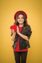 Valentines day. child on yellow backdrop. small girl kid with long curly hair. happy girl in beret leather jacket