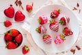 Valentines Day chocolate dipped strawberries, above view table scene against a white wood background