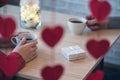 Valentines day.  Close-up of woman and man celebrating in restaurant. Boyfriend giving small box gift to girlfriend. View through Royalty Free Stock Photo