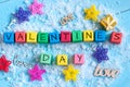 Valentines Day on colour wooden cubes On light blue background with stars. Love concept Royalty Free Stock Photo