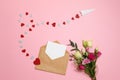 Valentines day composition : bouquet of flowers with ribbon bow, kraft envelope with blank white card for your text, airplane with Royalty Free Stock Photo