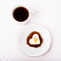 Valentines day composition with coffee cup and heart shape cake on white table. Top view. Copy space Royalty Free Stock Photo