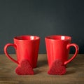 Valentines day composition with red coffee cups and heart of red velvet cake over board with chalckborad as background. Square ima Royalty Free Stock Photo