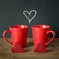 Valentines day composition with red coffee cups and heart of red velvet cake over wooden board with chalckborad. Square image. Royalty Free Stock Photo