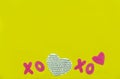 Valentines day composition. Yellow background with glistening pink XO, hand drawn big heart. Top view. Copy space