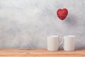 Valentines day concept with coffee cups and heart shape balloon