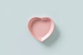 Valentines Day concept with empty pink plate heart shaped isolated on blue background