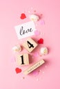 Valentines Day concept. February 14 wooden calendar, greeting card with the inscription love, pink and red hearts Royalty Free Stock Photo