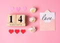 Valentines Day concept. February 14 wooden calendar, greeting card with the inscription love, pink and red hearts Royalty Free Stock Photo