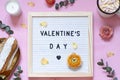 Valentines day concept flat lay with flowers, sweets and a board with text. Royalty Free Stock Photo