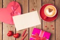 Valentines day concept with greeting card, gift box and coffee cup over wooden background. Top view Royalty Free Stock Photo