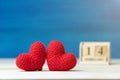 Valentines day concept. hand make two yarn red heart in front of wooden block calendar set on Valentines date 14 February on woode Royalty Free Stock Photo