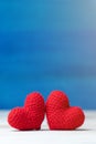Valentines day concept. hand make two yarn red heart on wooden table and blue backgroundValentines day concept. hand make two yarn Royalty Free Stock Photo