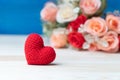 Valentines day concept. hand make yarn red heart in front of rose flower bouquet on wooden table and blue backgroundValentines day Royalty Free Stock Photo