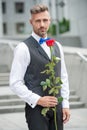valentines day concept. handsome tuxedo man with valentines rose. flower gift for valentines day