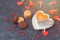 Valentines day concept with heart shape coffee cup and macarons over blackboard