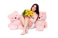 Valentines day concept. Lovely girl with presents - big soft teddy bears and large bouquet of spring flowers - yellow tulips.