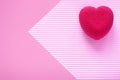 Valentines day concept. Pink velvet heart shaped cake on on a pink striped surface.