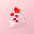 Valentines day concept red origami hearts coming out from pink envelope on pink pastel color background Royalty Free Stock Photo