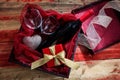 Valentines day. Red wine bottle, glasses and a gift in a box, wooden background Royalty Free Stock Photo