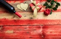 Valentines day. Red wine bottle, rose and a gift on wooden background Royalty Free Stock Photo