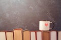 Valentines day concept with retro tea cup on books Royalty Free Stock Photo