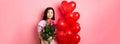 Valentines day concept. Romantic teen asian girl dreaming of love or date, close eyes and smile, holding flowers from Royalty Free Stock Photo